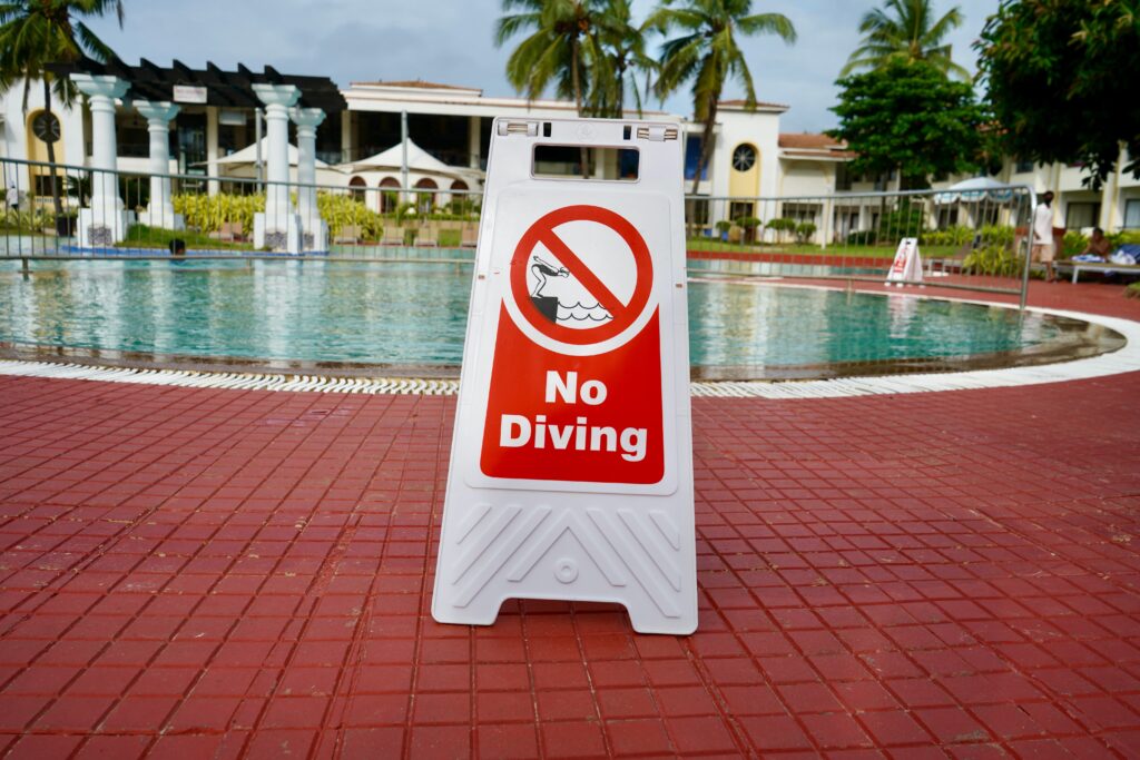 No diving sign in front of pool. 