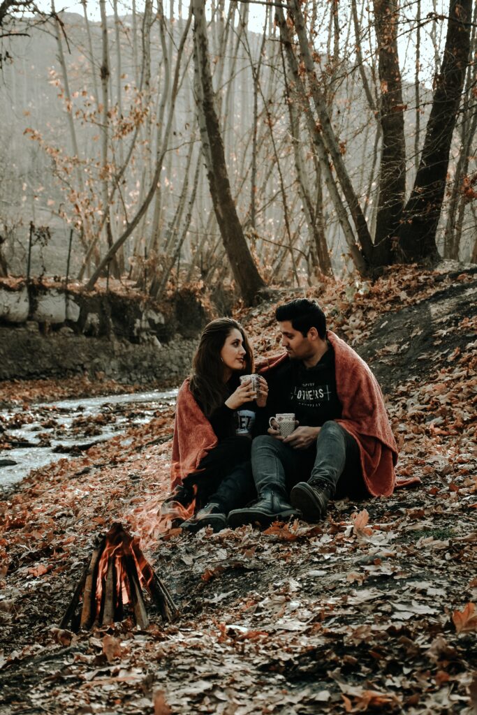 couple in the woods by a bonfire