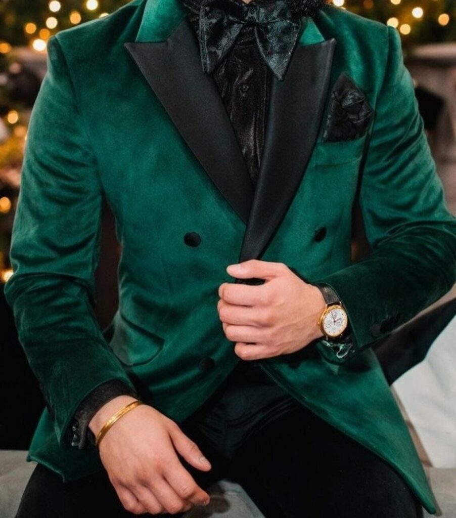 Winter Wedding Guest Attire: Man in velvet suit jacket with pocket square, bowtie, watch, and bracelet