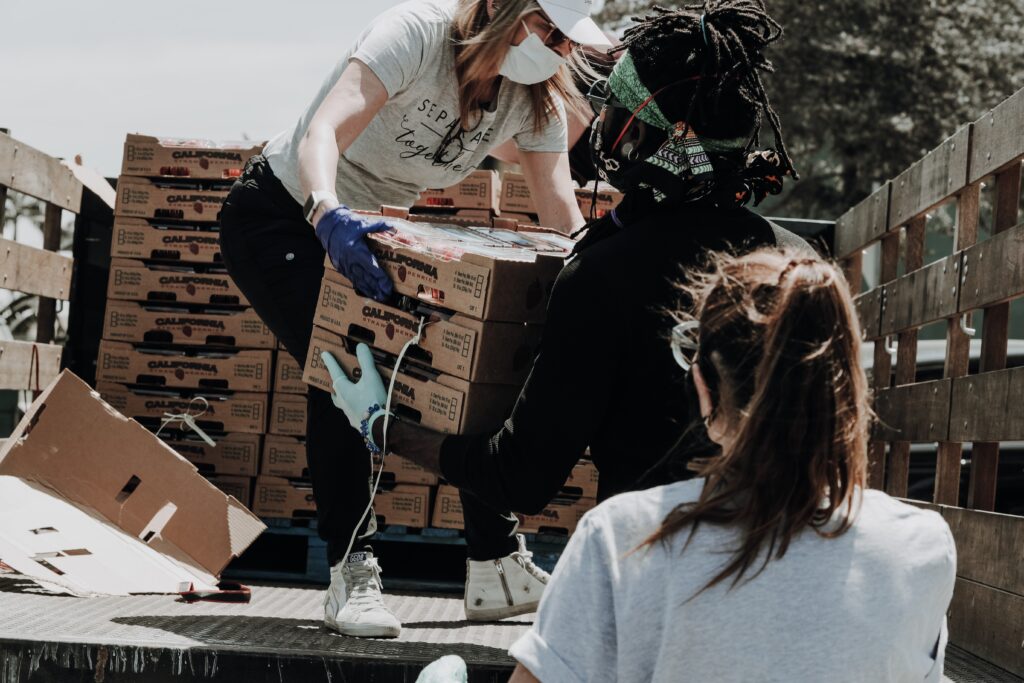 Wellness Love Language: volunteers unloading boxes from a truck. 