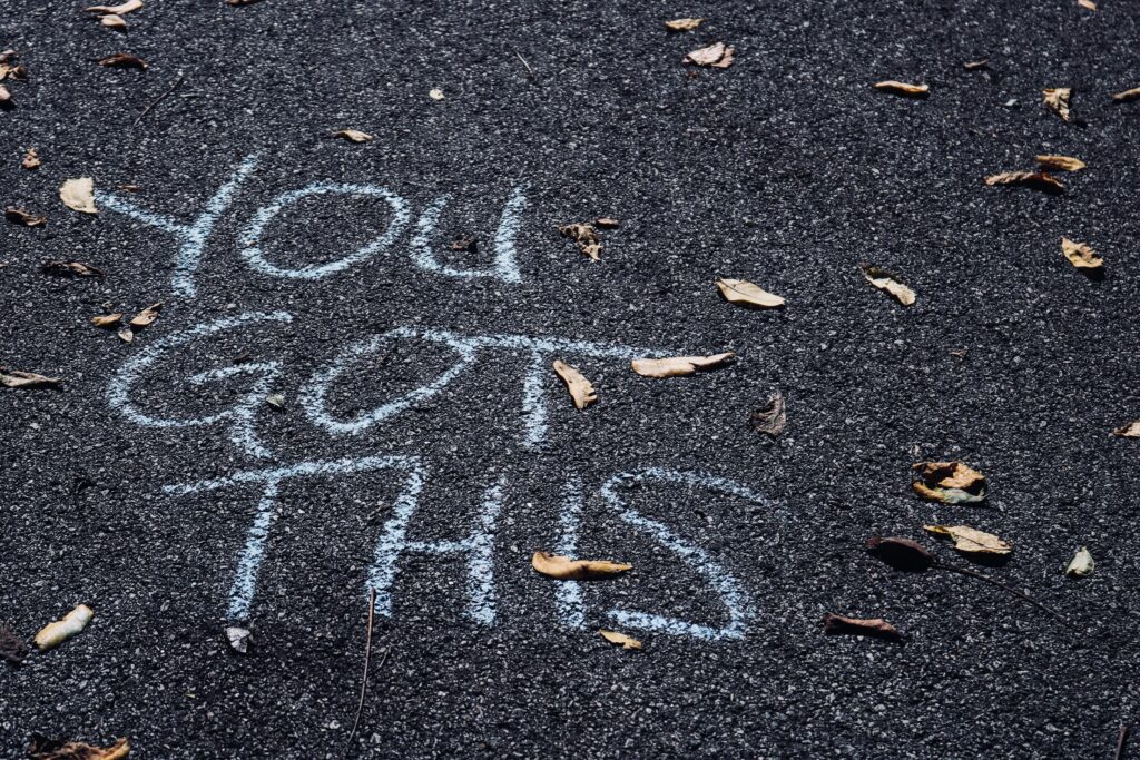 Wellness Love Language: "You Got This" written in chalk on pavement