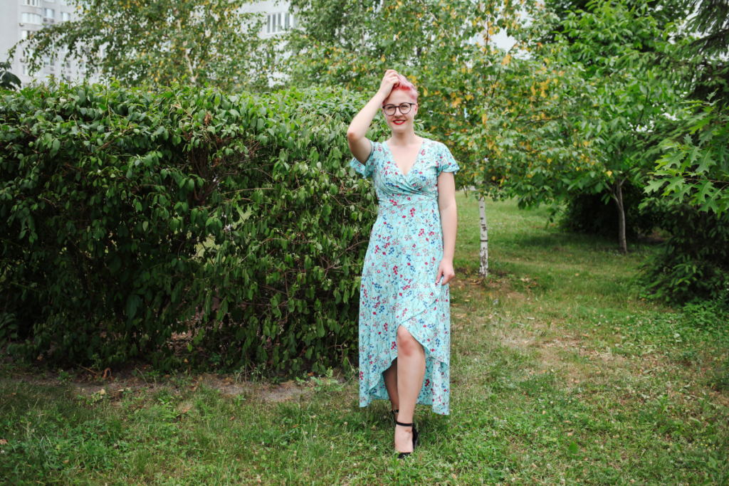 Woman wearing a floral midi dress walking in the grass