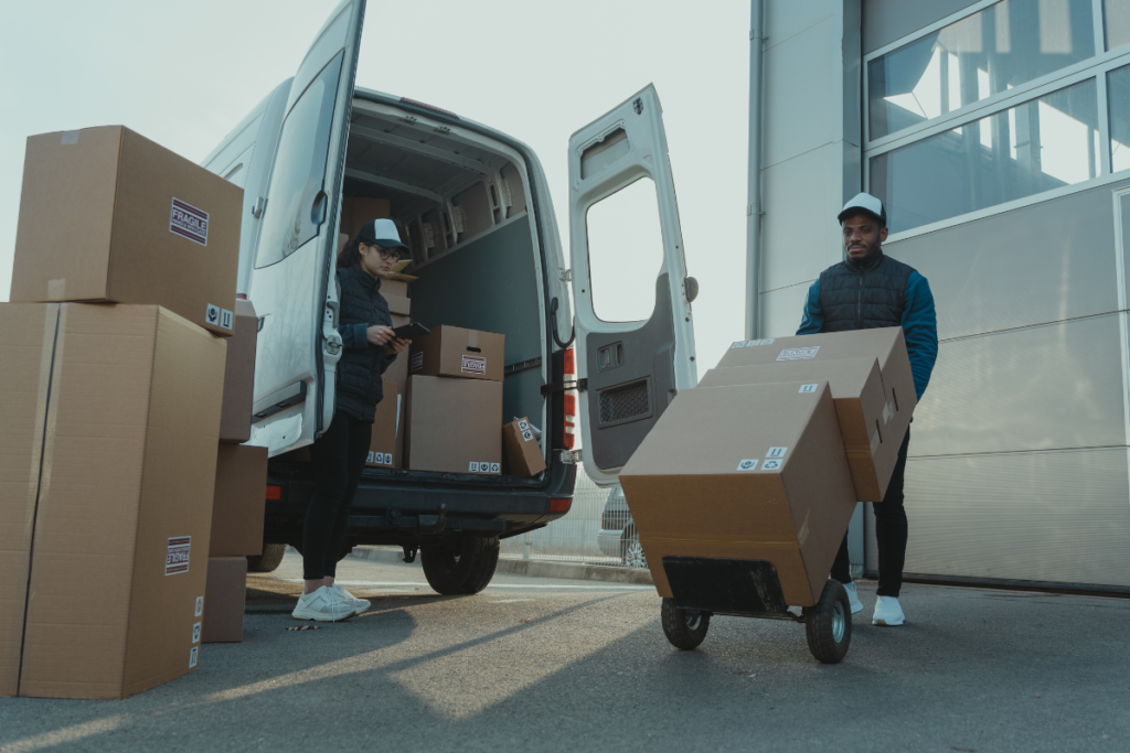 Man and woman moving boxes from a moving van