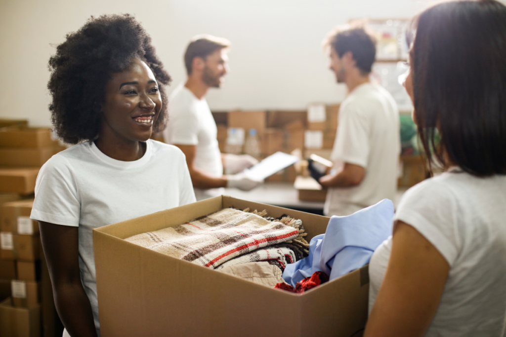 Women handling boxes at a volunteer clothing drive