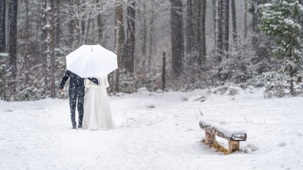 Bride and groom in a snowy forest