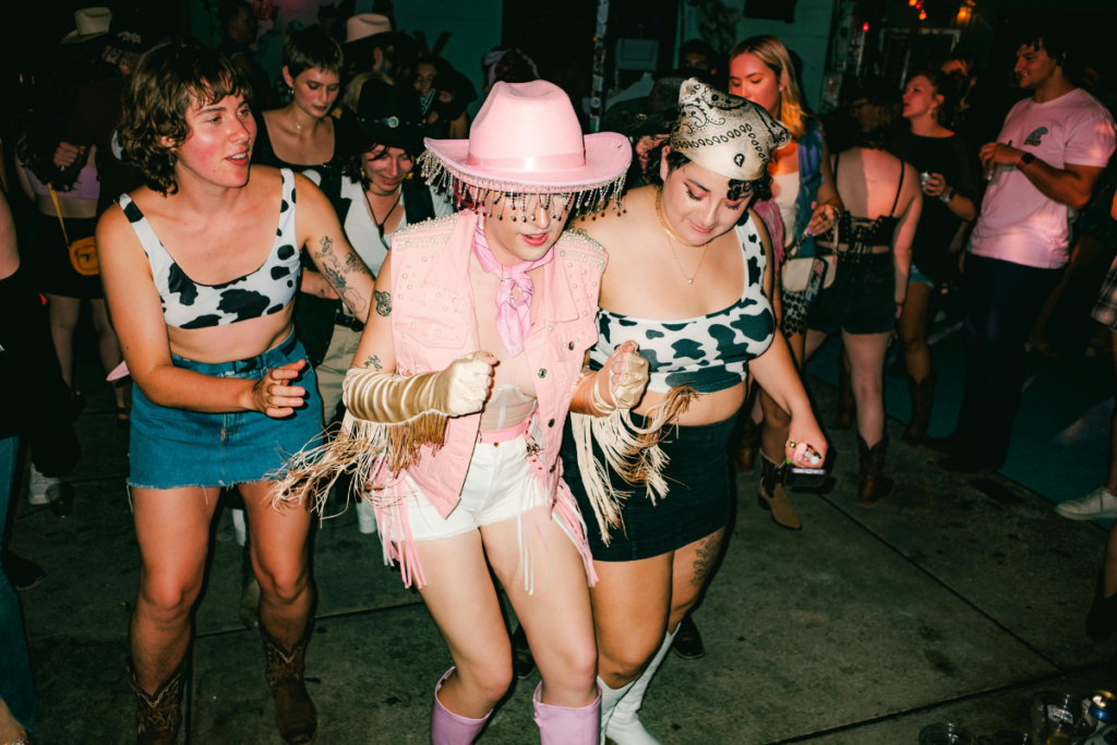 Women dressed in Halloween costumes dancing together