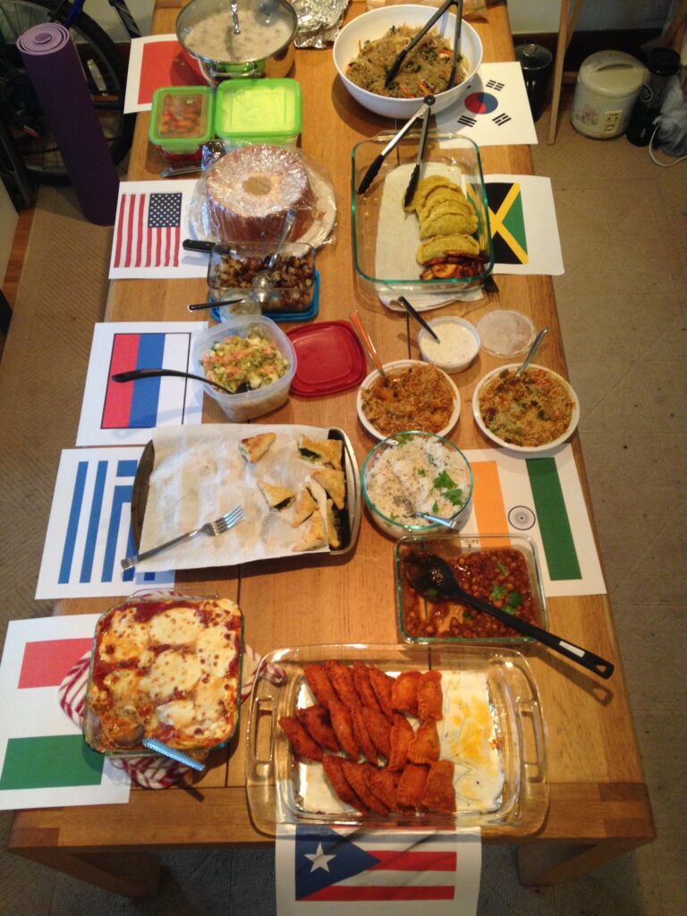 International meals on a table with corresponding flags