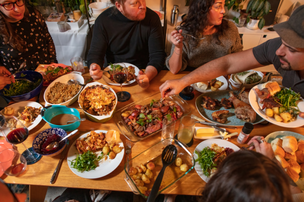 Friends gathered around a table of food