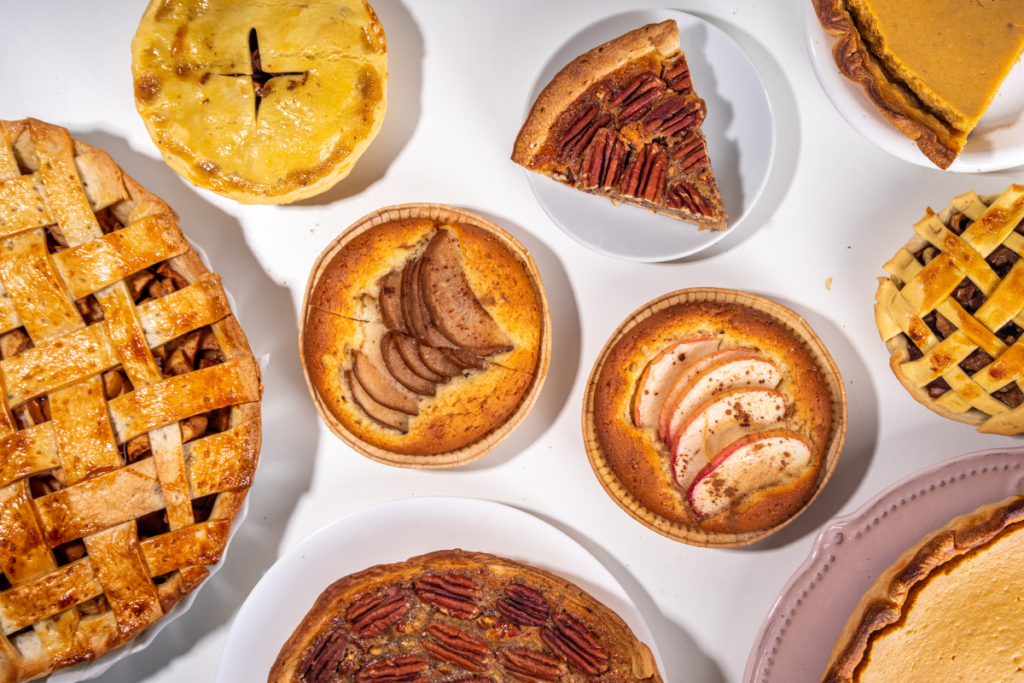 Variety of dessert pies on a white table
