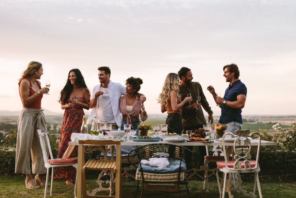 Group of people gathered outside around a table