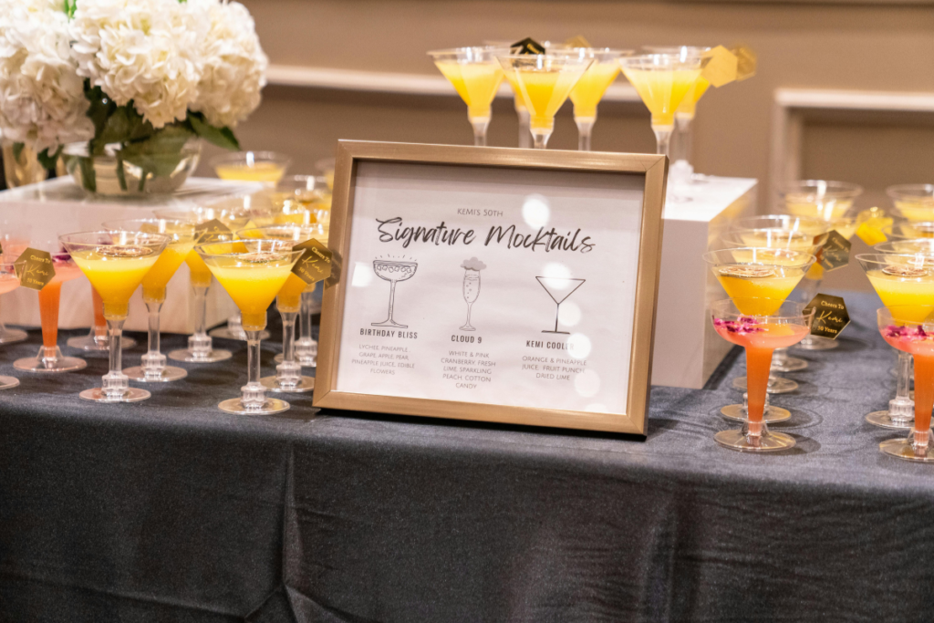 Signature mocktail sign on a table with mocktails