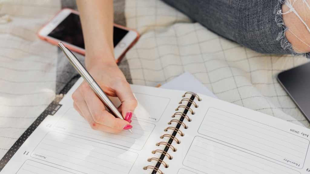 Woman writing in a calendar