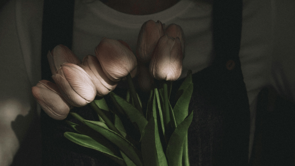 Person holding a tulip bouquet 