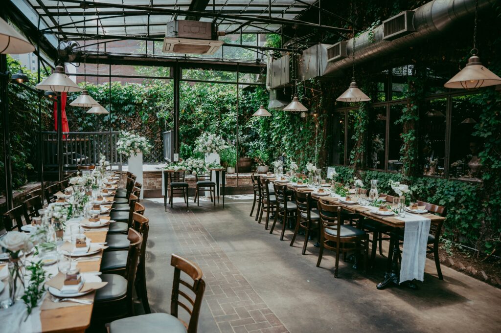 Wedding table settings in a lush greenhouse