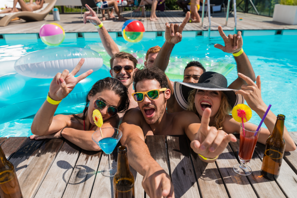 Group of men and women hanging out in a pool