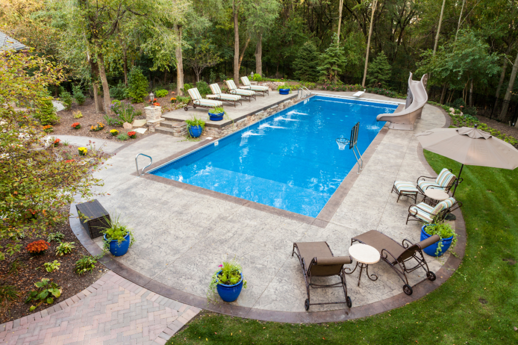 Outdoor pool set up with a waterslide